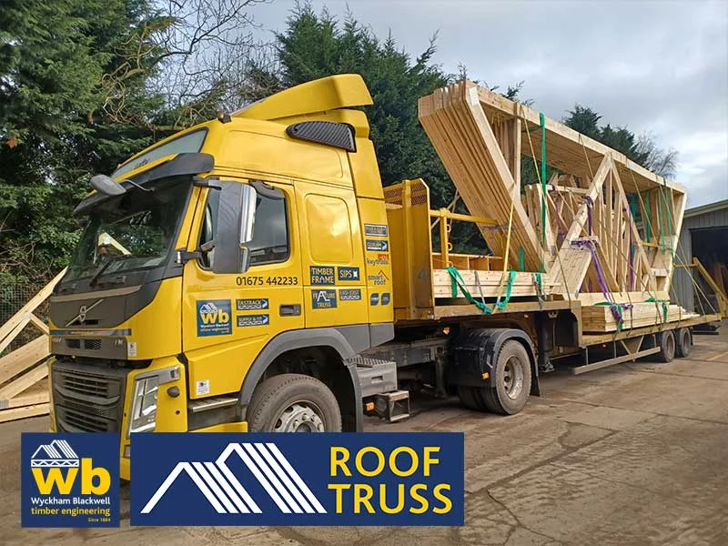 Lorry with timber roof trusses on bed